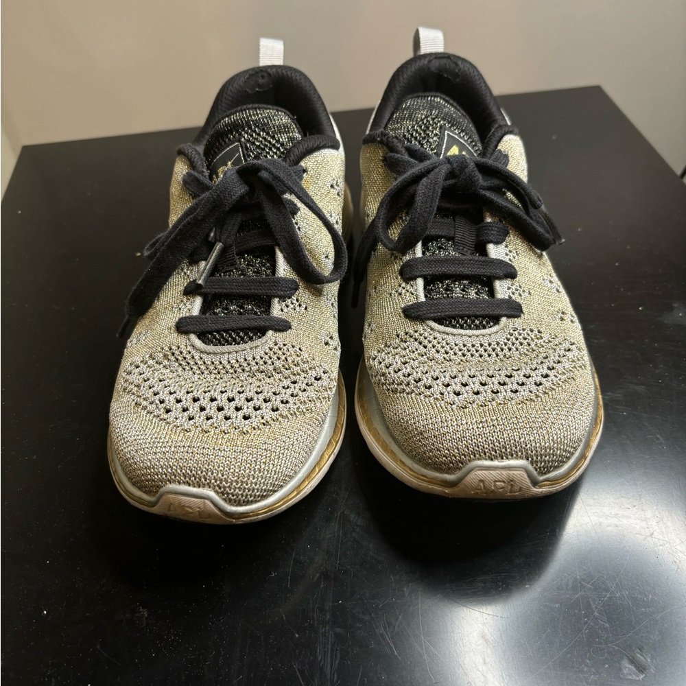 APL women’s size 7 silver with gold trim sneakers